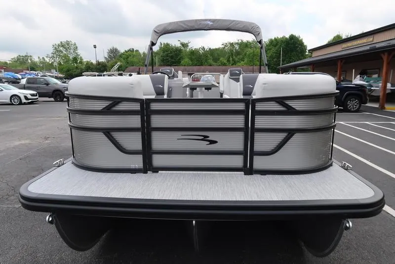 Slide: The Image of 2026 Bennington S Quad Bench 22 SSR pontoon boat, rear view in parking lot. - 3