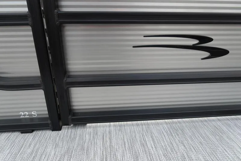 Slide: The Image of 2026 Bennington S Quad Bench 22 SSR pontoon side view with sleek design details. - 4