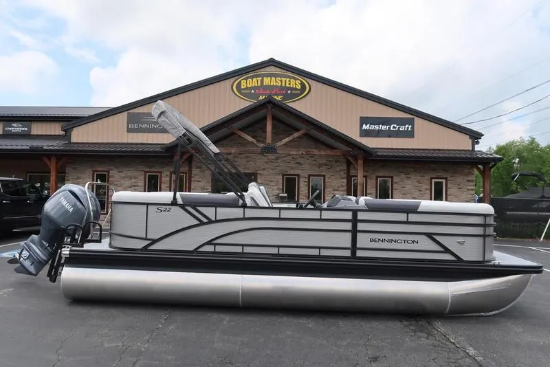 Slide: The Image of 2026 Bennington S Quad Bench 22 SSR pontoon boat outside dealership. - 5