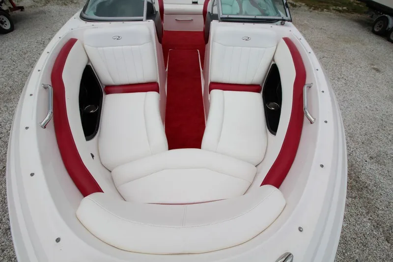 Slide: The Image of 2009 Regal 2200 Bowrider boat with white and red seating, viewed from above. - 13