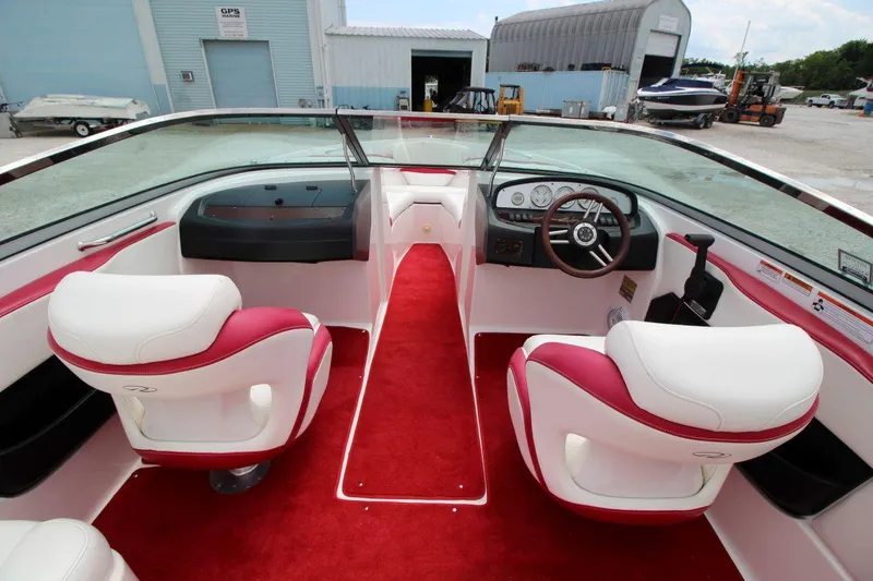 Slide: The Image of 2009 Regal 2200 Bowrider interior with red and white seating, dashboard, and steering wheel. - 14