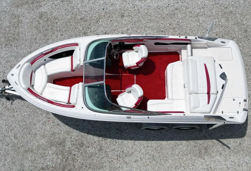 Slide: The Image of 2009 Regal 2200 Bowrider boat with white and red interior, aerial view. - 18