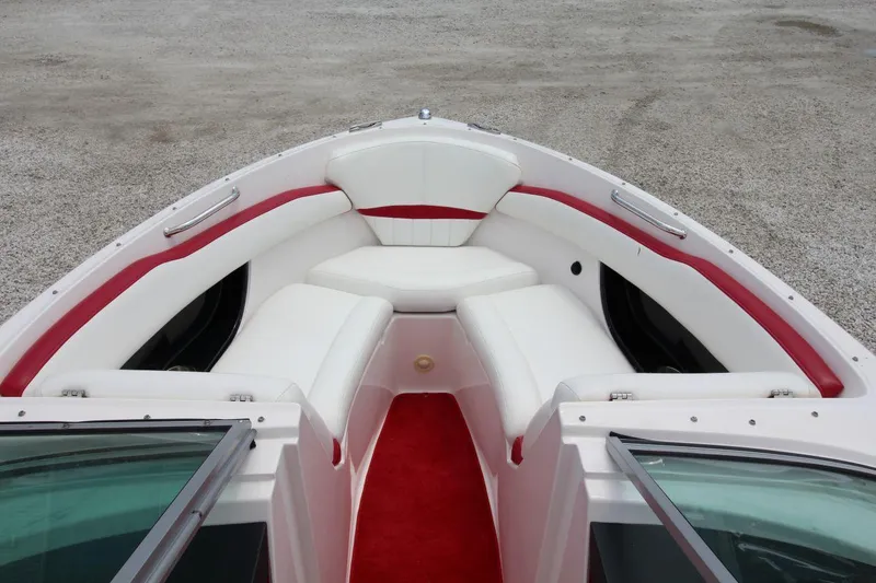 Slide: The Image of 2009 Regal 2200 Bowrider boat interior with white and red seating. - 22