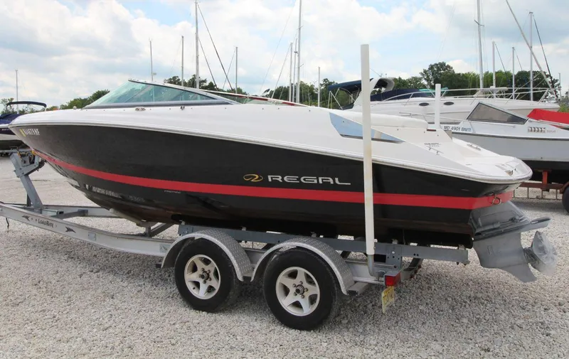 Slide: The Image of 2009 Regal 2200 Bowrider boat on trailer, parked in marina. - 6