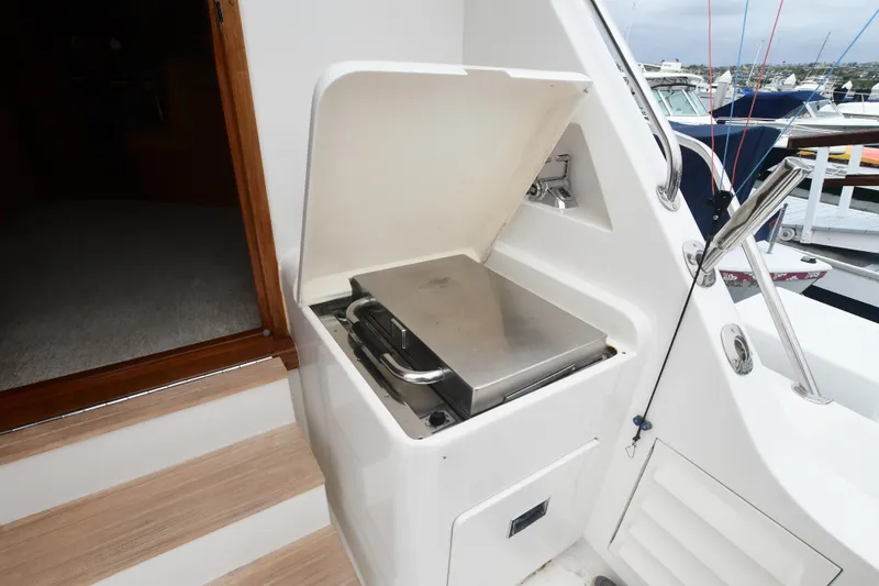 Slide: The Image of Outdoor grill on 1988 Bertram 54 Convertible yacht, docked at marina. - 11