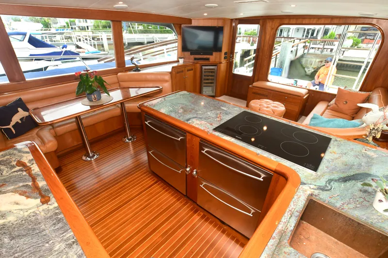 Slide: The Image of Luxurious interior of a 1988 Bertram 54 Convertible yacht with elegant wood finishes and modern amenities. - 13