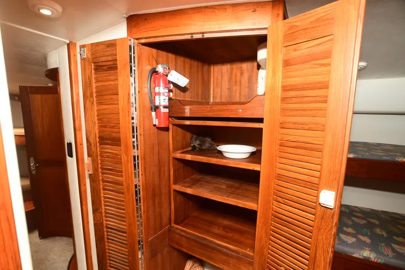 Slide: The Image of Wooden cabinet with fire extinguisher in 1988 Bertram 54 Convertible yacht interior. - 17