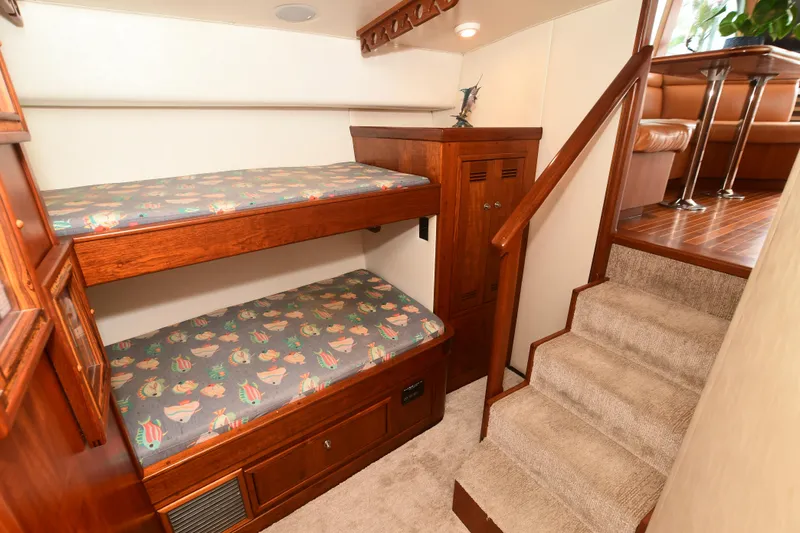 Slide: The Image of 1988 Bertram 54 Convertible interior with wooden bunk beds and carpeted stairs. - 23