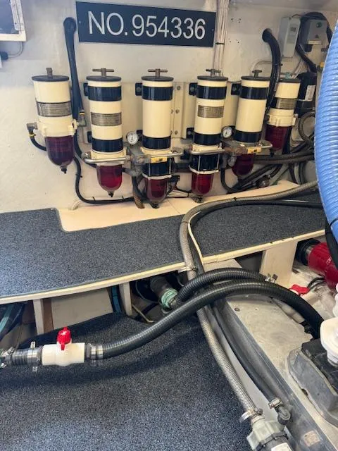 Slide: The Image of Engine room of 1988 Bertram 54 Convertible with fuel filters and hoses. - 28