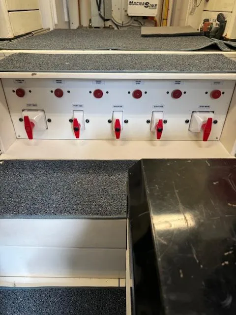 Slide: The Image of Electrical panel on a 1988 Bertram 54 Convertible boat with switches and controls. - 32