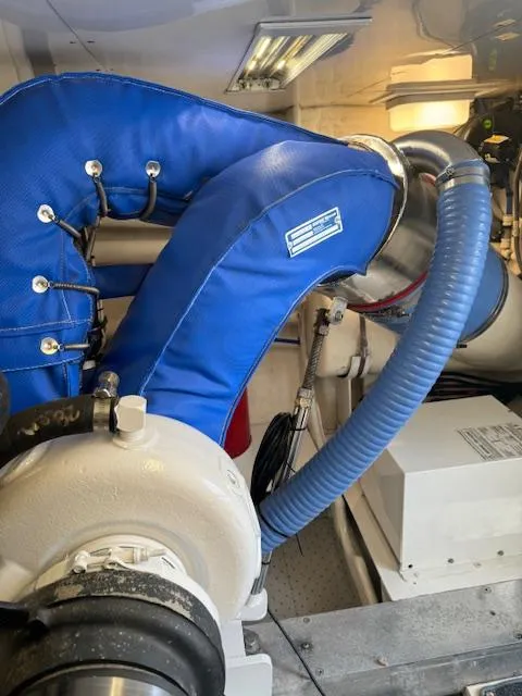 Slide: The Image of Engine room of a 1988 Bertram 54 Convertible with blue insulated piping. - 34