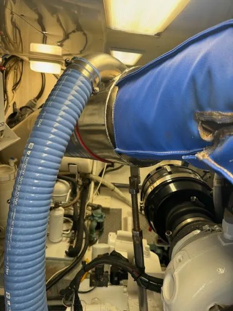Slide: The Image of Engine room of a 1988 Bertram 54 Convertible with visible hoses and machinery. - 35