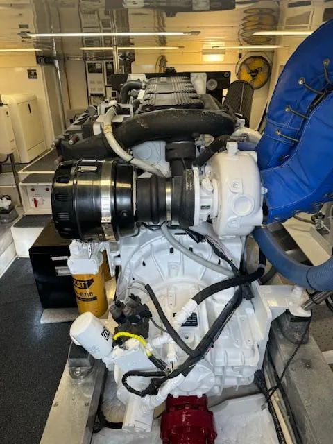 Slide: The Image of Engine room of a 1988 Bertram 54 Convertible yacht, showcasing detailed machinery. - 37