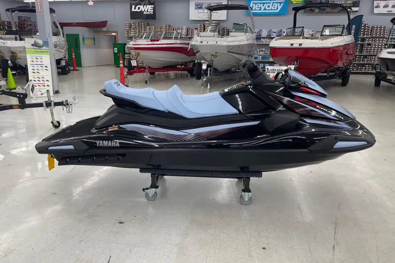 Slide: The Image of 2025 Yamaha WaveRunner VX Cruise in showroom, sleek black design with light blue seats. - 0