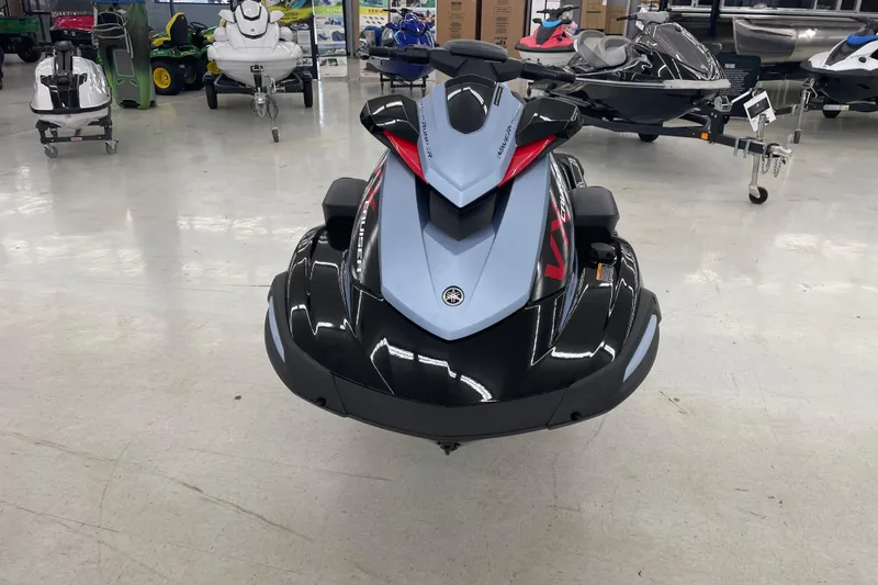 Slide: The Image of 2025 Yamaha WaveRunner VX Cruise in showroom, sleek black and blue design. - 2
