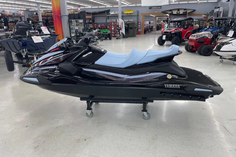 Slide: The Image of 2025 Yamaha WaveRunner VX Cruise in showroom, sleek black design with blue seating. - 4