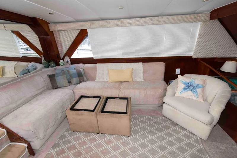 Slide: The Image of Cozy interior of 1985 Ocean Yachts 46 Sunliner with plush seating and nautical decor. - 10
