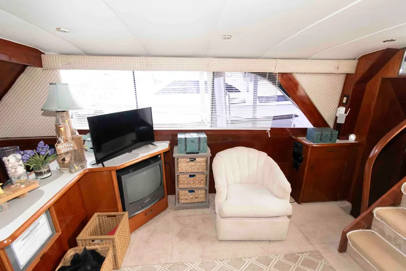 Slide: The Image of Interior of 1985 Ocean Yachts 46 Sunliner with cozy seating and entertainment area. - 11