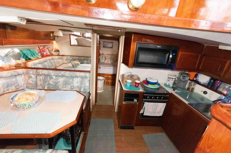 Slide: The Image of Interior of 1985 Ocean Yachts 46 Sunliner with kitchen and dining area. - 15