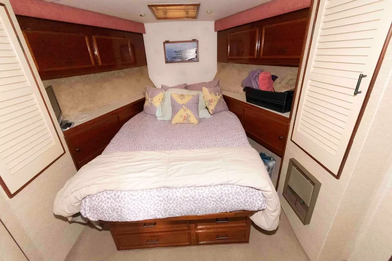 Slide: The Image of Cozy bedroom in 1985 Ocean Yachts 46 Sunliner with wood cabinets and soft bedding. - 19