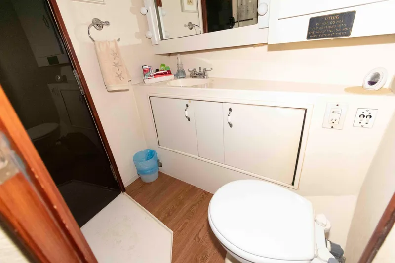 Slide: The Image of Bathroom interior of 1985 Ocean Yachts 46 Sunliner with sink, toilet, and mirror. - 20