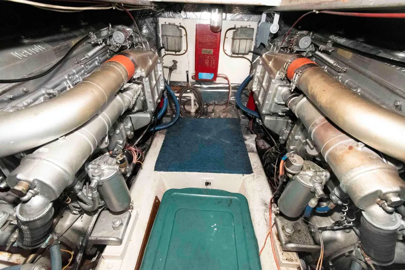 Slide: The Image of Engine room of 1985 Ocean Yachts 46 Sunliner with dual engines and mechanical components. - 22