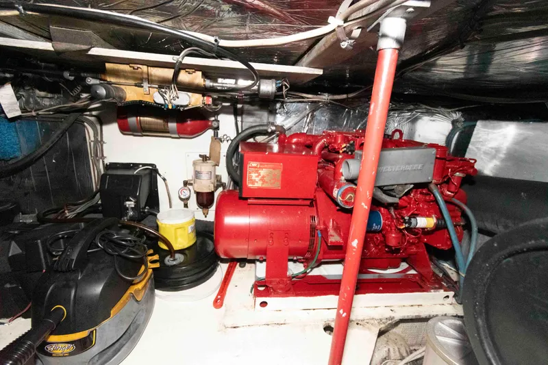 Slide: The Image of Engine room of 1985 Ocean Yachts 46 Sunliner with red machinery and equipment. - 25