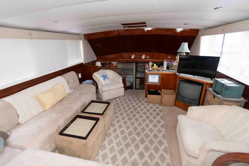 Slide: The Image of Interior of 1985 Ocean Yachts 46 Sunliner with cozy seating and entertainment area. - 9