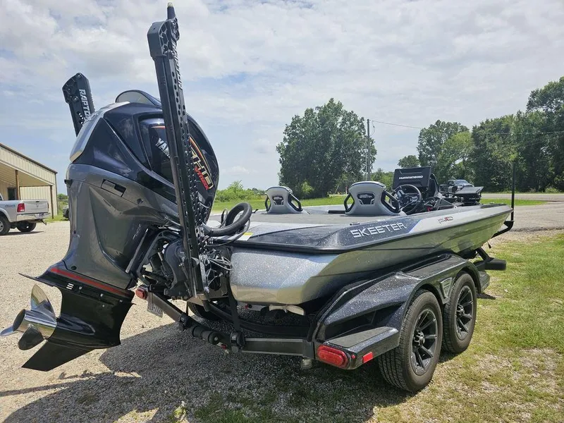 Slide: The Image of 2025 Skeeter FXR21 PRO boat with powerful outboard motor on a trailer. - 10