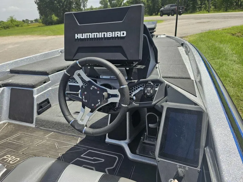 Slide: The Image of 2025 Skeeter FXR21 PRO boat dashboard with Humminbird electronics and modern steering wheel. - 12