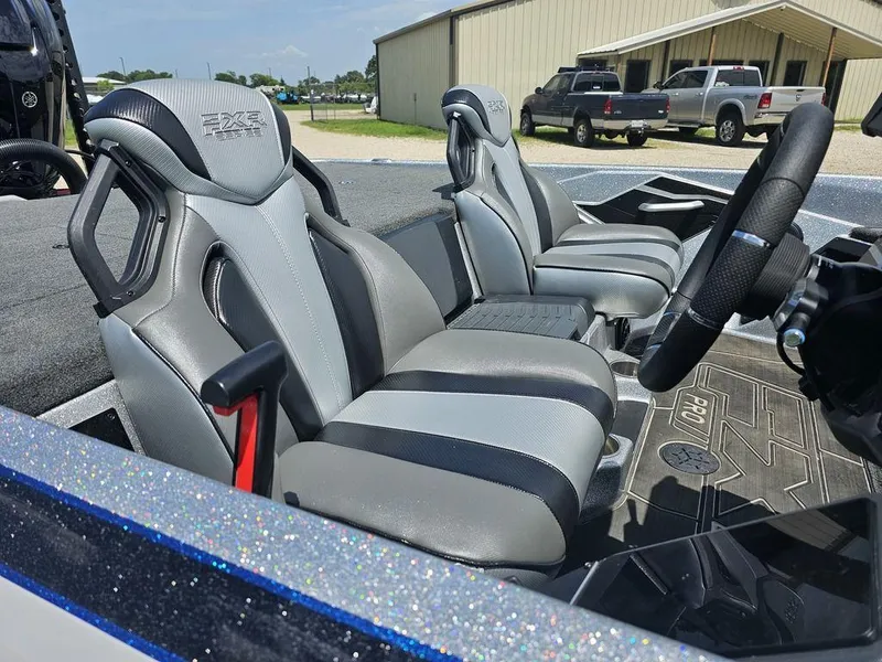 Slide: The Image of 2025 Skeeter FXR21 PRO boat interior with sleek, modern seating and steering wheel. - 15