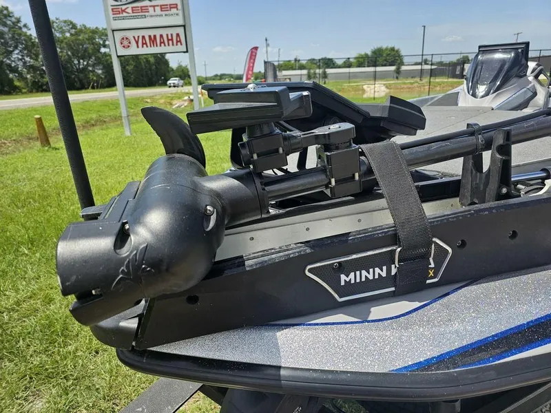 Slide: The Image of 2025 Skeeter FXR21 PRO boat with Minn Kota motor, Yamaha sign in background. - 2