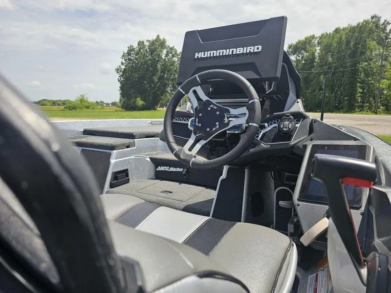 Slide: The Image of 2025 Skeeter FXR21 PRO boat cockpit with Humminbird electronics and modern steering wheel. - 7