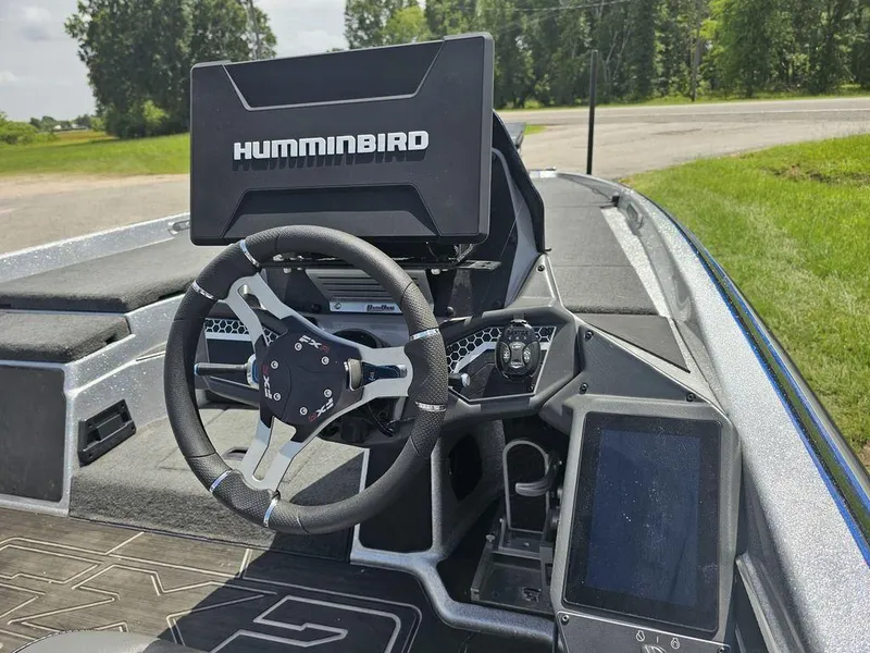 Slide: The Image of 2025 Skeeter FXR21 PRO boat dashboard with Humminbird electronics and modern steering wheel. - 8