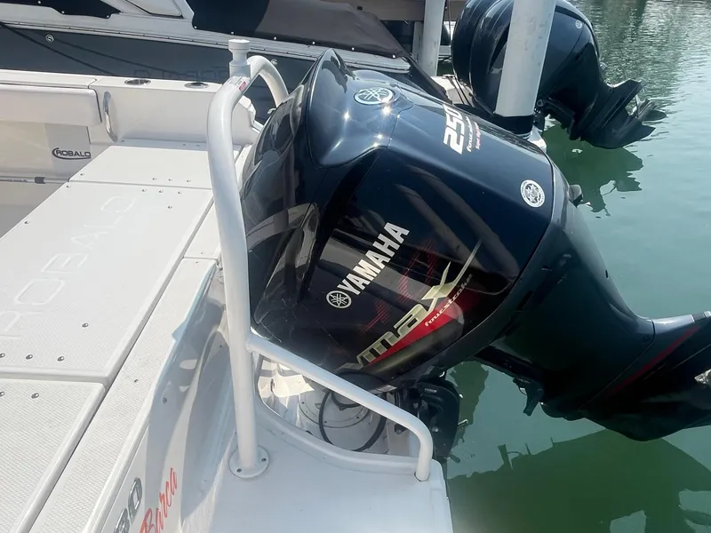 Slide: The Image of 2020 Robalo R230 Center Console with Yamaha outboard engine, docked on calm water. - 13