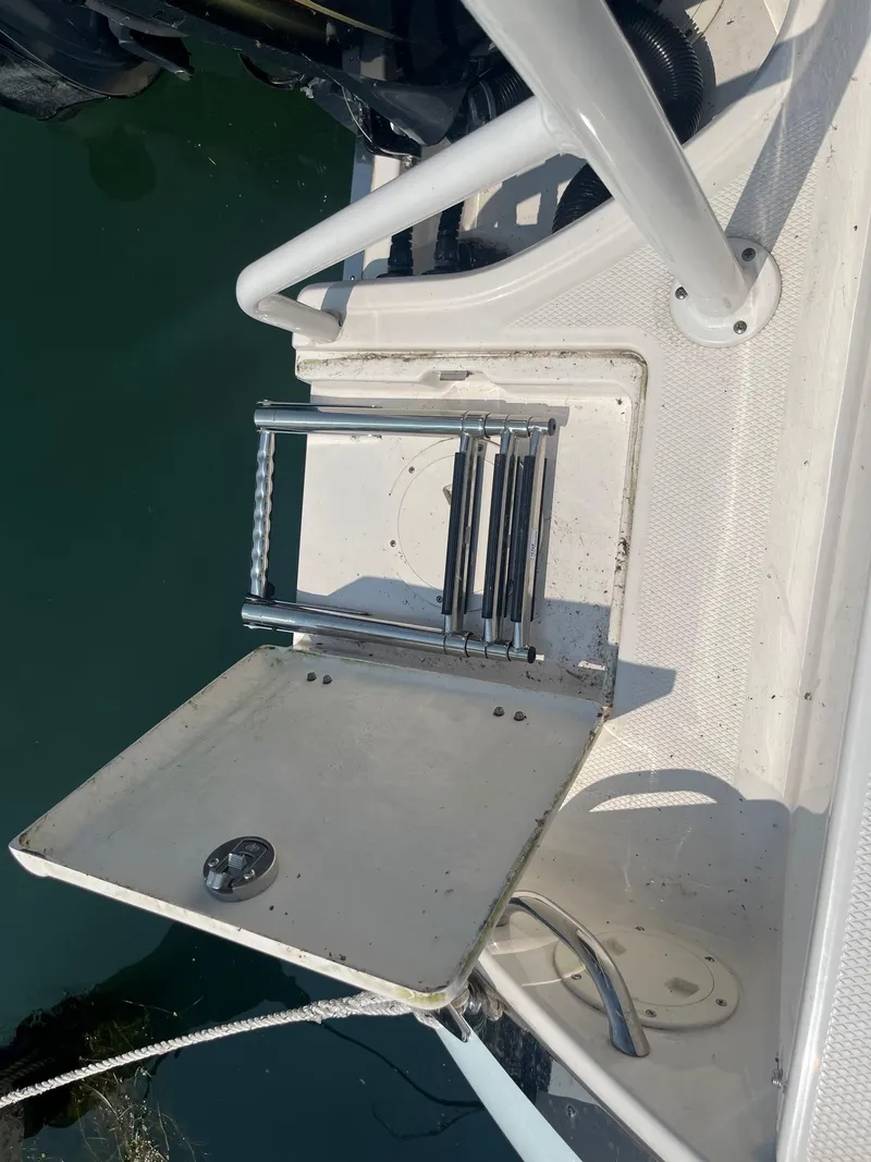 Slide: The Image of 2020 Robalo R230 Center Console boat with foldable swim ladder. - 15