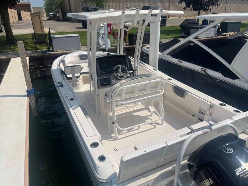 Slide: The Image of 2020 Robalo R230 Center Console boat docked, featuring a Yamaha outboard motor. - 2