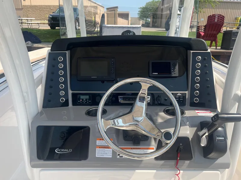 Slide: The Image of 2020 Robalo R230 Center Console dashboard with steering wheel and navigation controls. - 6