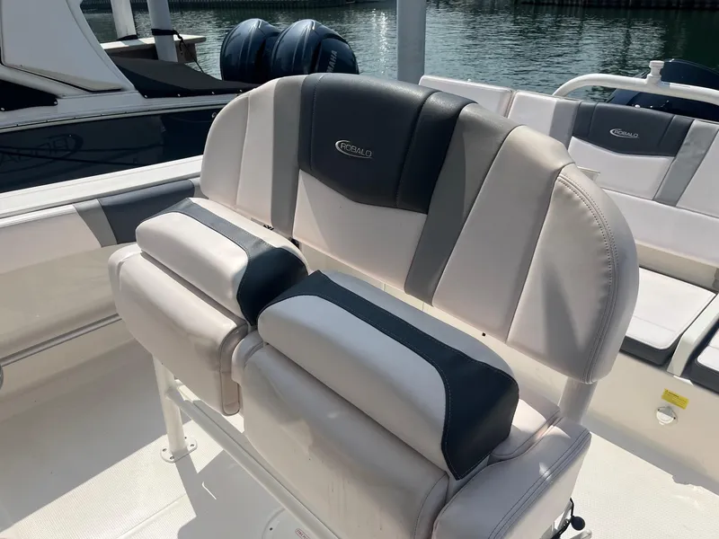 Slide: The Image of 2020 Robalo R230 Center Console boat seating with dual engines in background. - 8