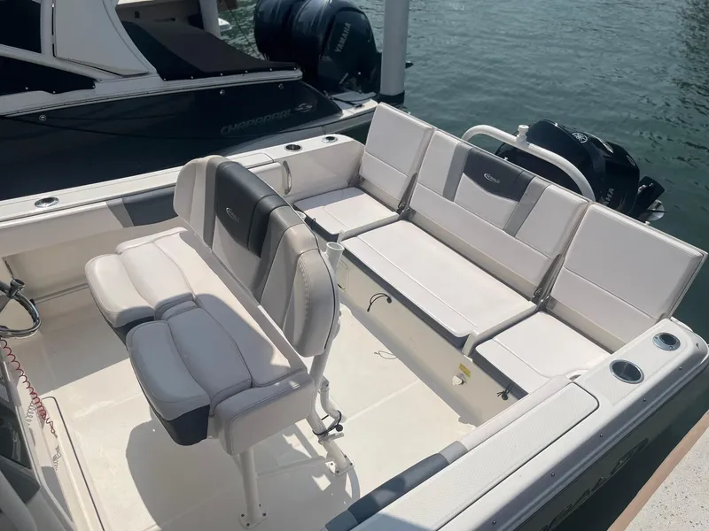 Slide: The Image of 2020 Robalo R230 Center Console boat interior with seating and cup holders. - 9