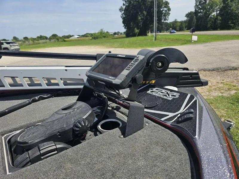 Slide: The Image of 2017 Skeeter FX21 LE boat dashboard with fishfinder and pedal controls. - 14