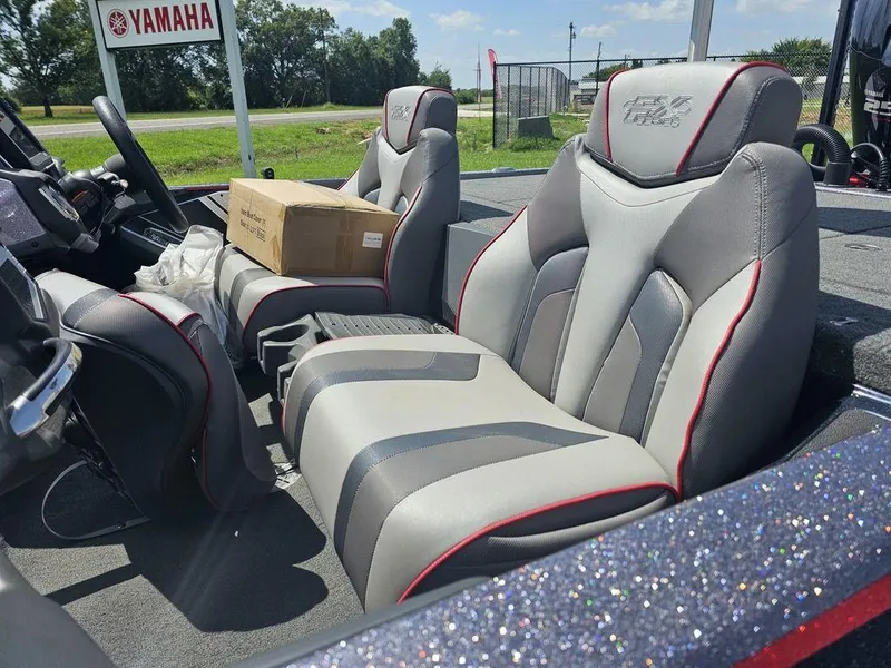 Slide: The Image of 2017 Skeeter FX21 LE boat interior with gray and red seats, Yamaha sign in background. - 4