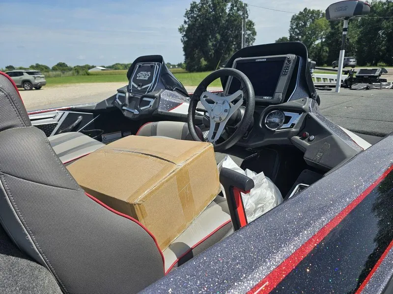 Slide: The Image of 2017 Skeeter FX21 LE boat interior with steering wheel and cardboard box on seat. - 6