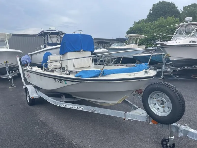 Slide: The Image of 1991 Boston Whaler 17 Outrage boat on trailer, parked in a marina. - 4