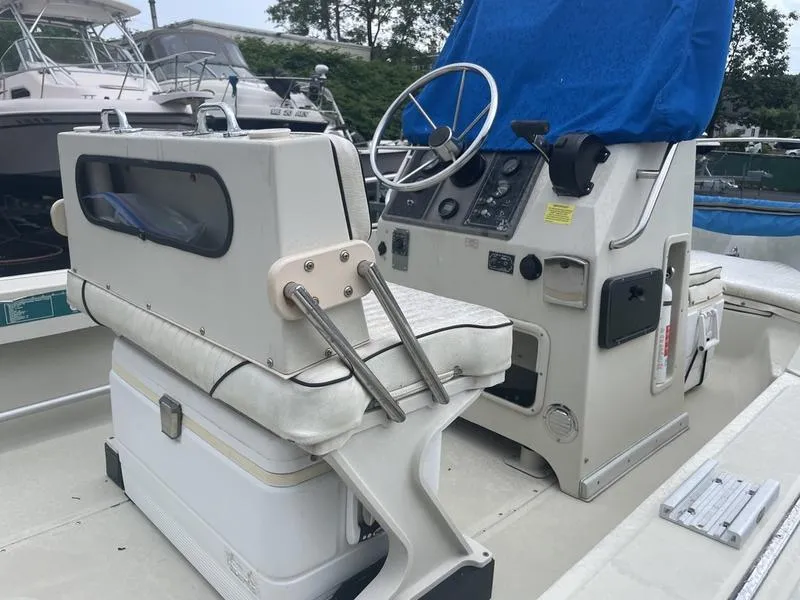 Slide: The Image of 1991 Boston Whaler 17 Outrage boat interior with steering console and seating. - 6