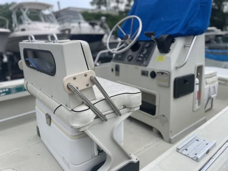 Slide: The Image of 1991 Boston Whaler 17 Outrage boat interior with steering console and seating. - 9