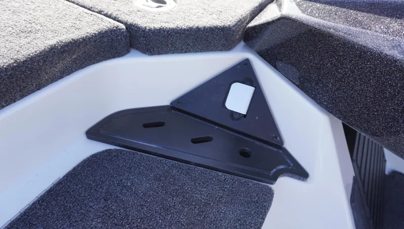 Slide: The Image of Interior detail of 2025 Ranger Z520 boat, featuring carpeted surfaces and a black triangular panel. - 15