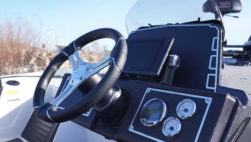 Slide: The Image of 2025 Ranger Z520 boat dashboard with steering wheel and gauges. - 3