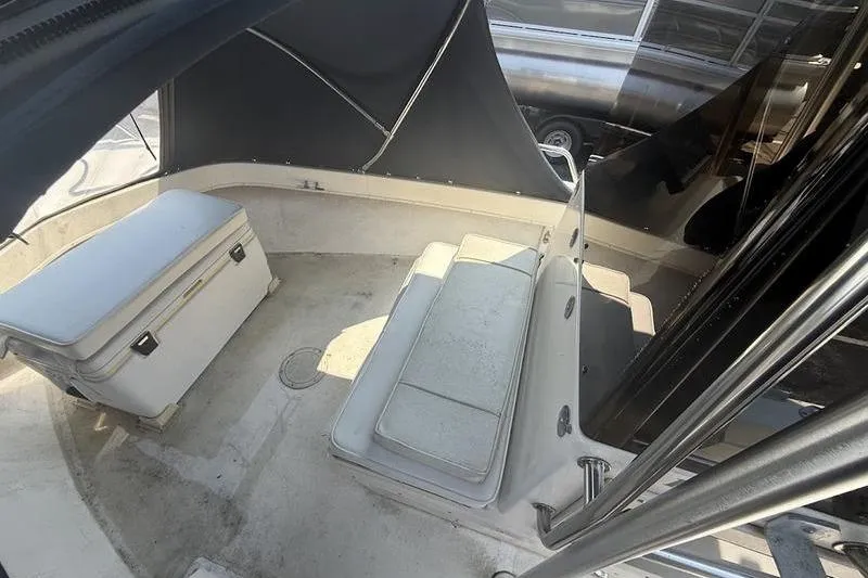 Slide: The Image of 1996 Parker 18 CC boat interior with seating and storage, featuring a covered area. - 11