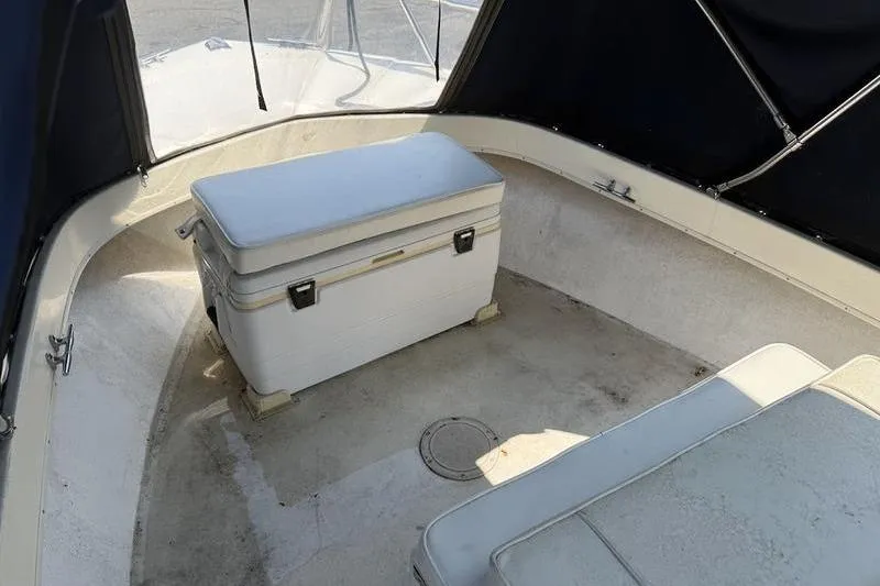 Slide: The Image of Interior of a 1996 Parker 18 CC boat with seating and storage. - 12